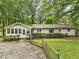 Back exterior view of a ranch-style home with a deck and fenced yard at 3015 Old Raleigh Rd, Apex, NC 27502
