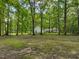 Spacious backyard with a large grassy area and mature trees at 3015 Old Raleigh Rd, Apex, NC 27502