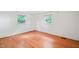 Hardwood floor bedroom with two windows and white walls at 3015 Old Raleigh Rd, Apex, NC 27502