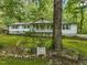 White ranch house with green lawn and mature trees at 3015 Old Raleigh Rd, Apex, NC 27502