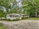 Front view of a charming white house with a gravel driveway at 3015 Old Raleigh Rd, Apex, NC 27502