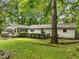 House exterior showcasing a white ranch home with green lawn at 3015 Old Raleigh Rd, Apex, NC 27502