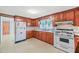 Kitchen with white appliances and wood cabinets at 3015 Old Raleigh Rd, Apex, NC 27502