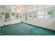 Sunroom with green carpet, ceiling fan and built-in cabinets at 3015 Old Raleigh Rd, Apex, NC 27502