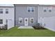 Charming back yard featuring a small patio, green grass, and a privacy fence at 553 Eversden Dr, Zebulon, NC 27597