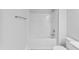 A clean, well-lit shower-tub combination in a modern, neutral-toned bathroom at 553 Eversden Dr, Zebulon, NC 27597