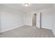 A spacious bedroom with a ceiling light, neutral walls, and carpet at 553 Eversden Dr, Zebulon, NC 27597