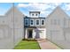 Beautiful townhome with manicured lawn and a driveway leading to an attached garage at 553 Eversden Dr, Zebulon, NC 27597
