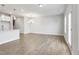 Bright living room with hardwood floors, recessed lighting, and a view of the kitchen and staircase at 553 Eversden Dr, Zebulon, NC 27597