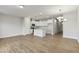 Open-concept living space showcasing the kitchen with stainless steel appliances and the dining area with modern lighting at 553 Eversden Dr, Zebulon, NC 27597