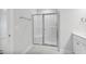 Modern bathroom with shower featuring glass door and tiled walls at 553 Eversden Dr, Zebulon, NC 27597