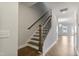 Staircase with wooden steps and railing, white walls, and hardwood floors in the entryway at 553 Eversden Dr, Zebulon, NC 27597
