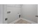 A utility room with vinyl flooring and utility connections at 553 Eversden Dr, Zebulon, NC 27597