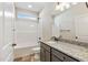 Bathroom featuring a shower-tub combo, tile floors, and a granite vanity at 258 Thistle Ct, Sanford, NC 27332