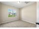 Bright bedroom featuring a large window, neutral walls, and cozy carpet at 258 Thistle Ct, Sanford, NC 27332