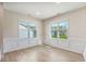Dining area featuring wainscoting, hardwood floors, and views of the lawn at 258 Thistle Ct, Sanford, NC 27332