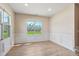 Bright dining room with wainscoting, hardwood floors, and large windows at 258 Thistle Ct, Sanford, NC 27332