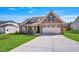 Charming single-Gathering home with a manicured lawn, stone accents, and a two-car garage at 258 Thistle Ct, Sanford, NC 27332