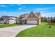Charming single-Gathering home with a manicured lawn, stone accents, and a two-car garage at 258 Thistle Ct, Sanford, NC 27332