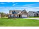 Charming single-Gathering home with a manicured lawn, stone accents, and a two-car garage at 258 Thistle Ct, Sanford, NC 27332