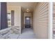 Inviting entryway with a classic front door, stone accents, and a well-lit porch area at 258 Thistle Ct, Sanford, NC 27332