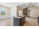 Open kitchen with granite island overlooking the living room and stone fireplace at 258 Thistle Ct, Sanford, NC 27332