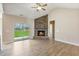 Bright living room featuring a stone fireplace, hardwood floors, and a sliding glass door at 258 Thistle Ct, Sanford, NC 27332