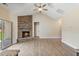 Spacious living room featuring a stone fireplace, hardwood floors, and vaulted ceiling with ceiling fan at 258 Thistle Ct, Sanford, NC 27332