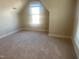 Well-lit bedroom featuring neutral carpeting at 49 Danbury Ct, Pittsboro, NC 27312