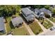 An aerial view showing the home's exterior, neighboring homes, lawn, and mature trees at 605 Quarry St, Raleigh, NC 27601
