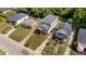 An aerial view displays the home's exterior, neighboring houses, lawns, and mature trees at 605 Quarry St, Raleigh, NC 27601