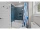 Bathroom features stylish blue tiling and a shower over the tub at 605 Quarry St, Raleigh, NC 27601