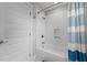 Bathroom features a tub, a shower, a subway tile surround, and a blue shower curtain at 605 Quarry St, Raleigh, NC 27601