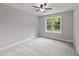 Carpeted bedroom features natural light and ample space at 605 Quarry St, Raleigh, NC 27601