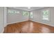 A bright bedroom featuring hardwood floors and multiple windows providing natural light at 605 Quarry St, Raleigh, NC 27601
