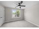 Bedroom featuring a fan and a bright window showing views of the neighborhood at 605 Quarry St, Raleigh, NC 27601