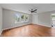 Bright bedroom featuring hardwood floors, multiple windows providing natural light, and an ensuite bathroom at 605 Quarry St, Raleigh, NC 27601