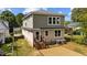 View of the back of the home featuring a staircase, door, vinyl siding, and a gravel patio at 605 Quarry St, Raleigh, NC 27601