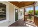 Inviting front porch features a wood railing and ceiling, along with a striking green front door at 605 Quarry St, Raleigh, NC 27601