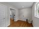 Bright laundry room features hardwood floors and a convenient laundry hamper at 605 Quarry St, Raleigh, NC 27601