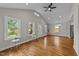 Bright living area featuring hardwood floors, neutral paint, and large windows at 605 Quarry St, Raleigh, NC 27601