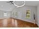 Inviting living area with hardwood floors, large windows, and modern lighting fixtures at 605 Quarry St, Raleigh, NC 27601
