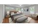 Well-appointed main bedroom featuring wood floors, bright natural light, and stylish decor at 605 Quarry St, Raleigh, NC 27601