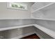 A walk-in pantry featuring multiple shelves and dark-stained hardwood floors at 605 Quarry St, Raleigh, NC 27601