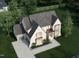 Aerial view of new two-story home with paved driveway, two-car garage, and green lawn at 217 Dublin Rd, Raleigh, NC 27609