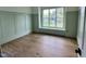 Bright, airy bedroom with hardwood floors, paneled walls, and a large window with a window seat at 217 Dublin Rd, Raleigh, NC 27609
