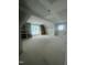 Unfinished bonus room with built-in bookshelves, window, and temporary flooring at 217 Dublin Rd, Raleigh, NC 27609