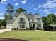 Stylish two-story home featuring manicured lawn, attached garage, and classic architectural accents at 217 Dublin Rd, Raleigh, NC 27609