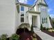 Close up of the exterior, showcasing the covered front entrance with detailed trim and fresh landscaping at 217 Dublin Rd, Raleigh, NC 27609