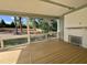 Relaxing outdoor porch with fireplace, wooden flooring and serene views of the treed backyard at 217 Dublin Rd, Raleigh, NC 27609